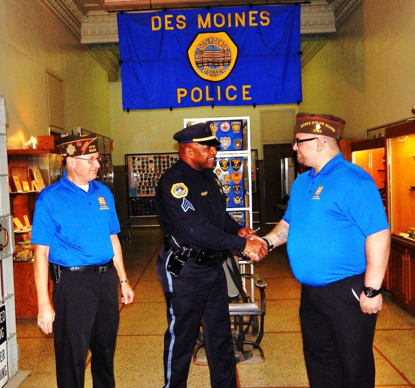 Senior Vice Dennis Applehous and Junior Vice Chris McClaskey present a donation check to Des Moines police Sgt. Bernell Edwards.